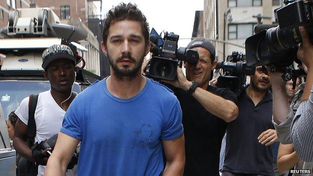 Shia LaBeouf being followed by people with cameras