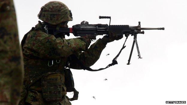 Soldiers from the Japan Ground Self-Defense Force's Western Army Infantry Regiment fire live ammunition during a joint exercise with US Marines and sailors on 9 February, 2014