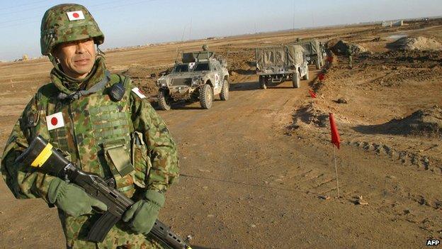 A Japanese soldier stands on guard during a visit by Japanese Self-Defence Force Commander Lt-Col Masahisa Sato to the area where a Japanese military base for troops in Iraq will be established in al-Muthanna province on 28 January 2004