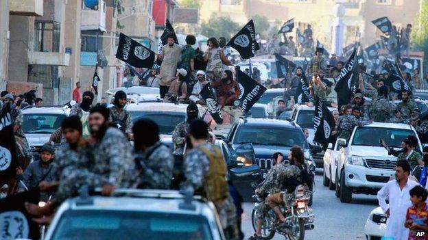 Isis fighters during a parade in Raqqa, Syria in July 2014