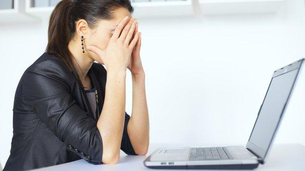 Woman at a computer (pic posed by model)