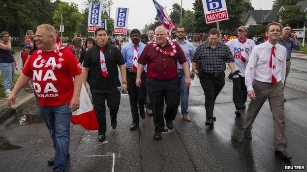 Toronto Mayor Rob Ford (C) and his brother Doug (L) take part in the East York Canada Day Parade in the mayor's first public appearance since returning from a rehabilitation clinic for substance abuse problems in Toronto 1 July 2014