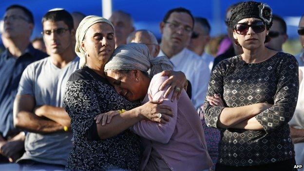 The mothers of two of the three Israeli teenagers killed in the West Bank mourn during the funeral of their sons on 1 July 2014 in the cemetery of Modiin in central Israel.