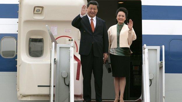 Chinese President Xi Jinping and Chinese first lady Peng Liyuan wave upon their arrival at Seoul Military Airport in Seongnam, South Korea on Thursday, 3 July, 2014