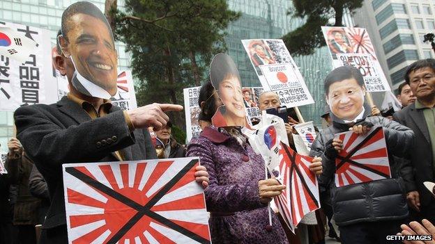 South Korean conservative protesters wear masks of US President Barack Obama, South Korean President Park Geun-hye and Chinese President Xi Jinping in front of Japanese embassy on 1 March, 2014 in Seoul, South Korea