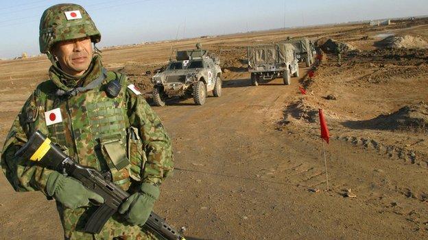 A Japanese soldier stands on guard during a visit by Japanese Self-Defence Force Commander Lt-Col Masahisa Sato to the area where a Japanese military base for troops in Iraq will be established in al-Muthanna province on 28 January 2004