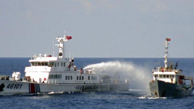 A Chinese coastguard vessel uses water cannon on a Vietnamese Sea Guard ship on the South China Sea near the Paracels islands, in this handout photo taken on 4 May, 2014 and released by Vietnam Marine Guard on 8 May, 2014