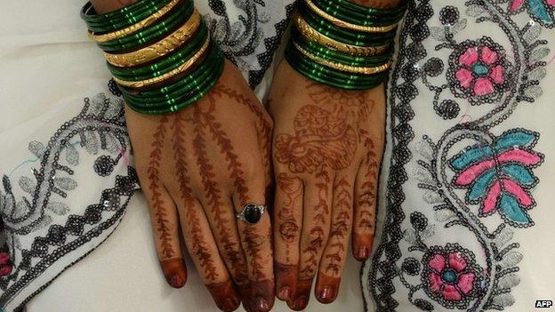 Mehendi (henna)-decorated hands of an Indian bride