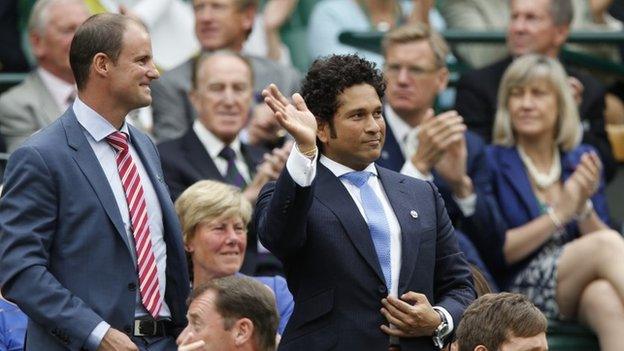 Former Indian cricketer Sachin Tendulkar, right, waves, with ex-England cricketer Andrew Strauss, left, from the Royal Box on centre court at the All England Lawn Tennis Championships in Wimbledon, London, Saturday, June 28, 2014