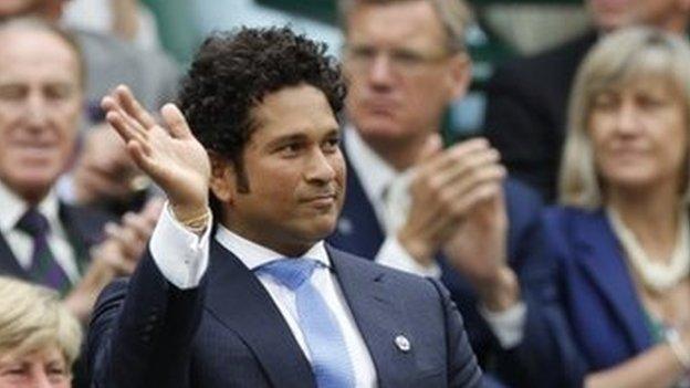 India cricketer Sachin Tendulkar right, waves with England cricketer Andrew Strauss, left, from the Royal Box on centre court at the All England Lawn Tennis Championships in Wimbledon, London, Saturday, June 28, 2014.