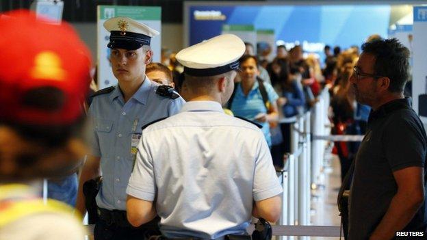 Police officers and passengers in an airport