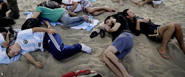 Fans sleep on the beach at the 2014 World Cup