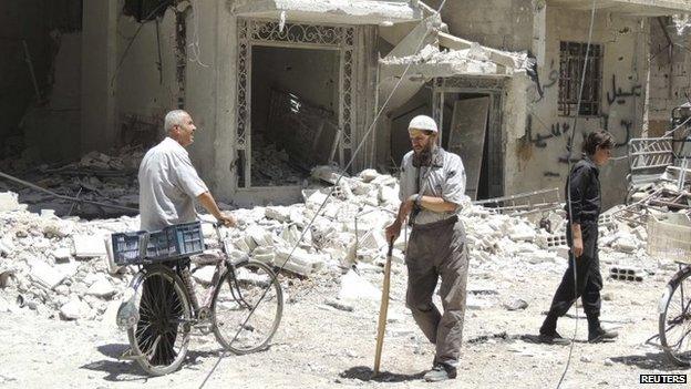 Residents view damage in a Damascus suburb