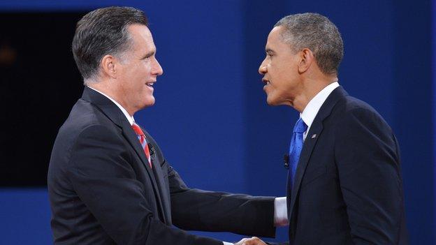 Mitt Romney and Barack Obama shake hands after a debate.