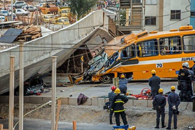 Firefighters inspect the bus that was crushed by a flyover that collapsed in Belo Horizonte - 3 July 2014