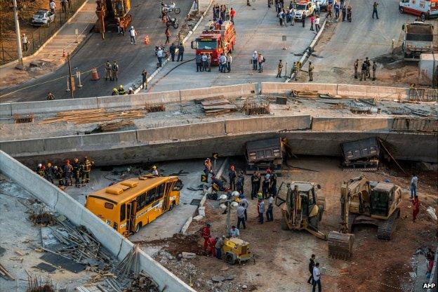 Rescue workers at the site where a bus, two trucks and a car were crushed in Belo Horizonte - 3 July 2014