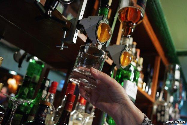 Woman serves alcohol in pub