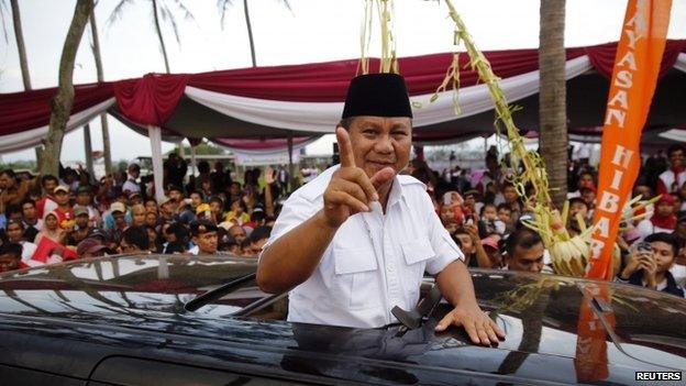 Indonesian presidential candidate Prabowo Subianto gestures as he leaves a campaign rally in Ciparay near Bandung, West Java