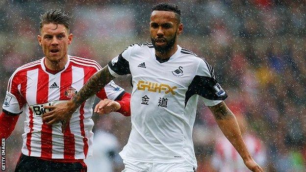 Kyle Bartley challenges for the ball with Connor Wickham