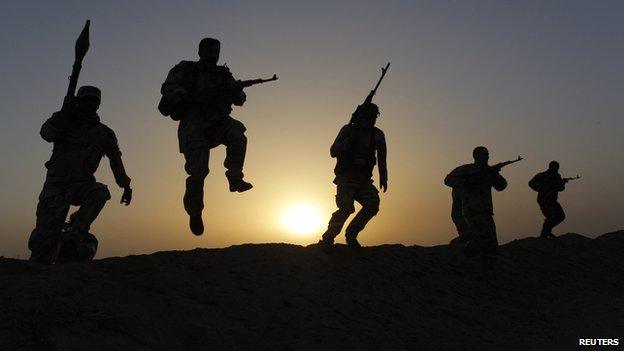 Shi"ite volunteers patrol the area as they secure it against the predominantly Sunni militants from the Islamic State, previously called the Islamic State in Iraq and the Levant (ISIL), in the desert region between Kerbala and Najaf, south of Baghdad, July 3