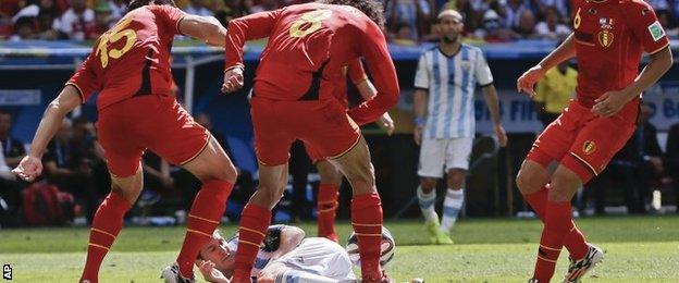 Belgium players foul Lionel Messi