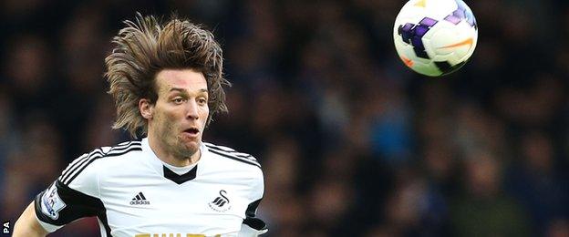 Michu heads the ball for Swansea last season