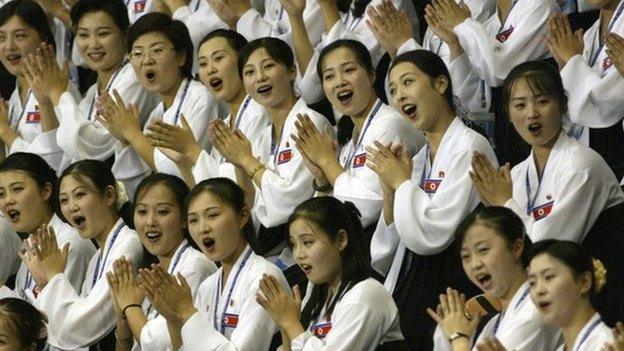 In this photo taken on 21 Aug 2003, North Korean women cheer at the Daegu Universiade Games in Daegu, south of Seoul, South Korea.