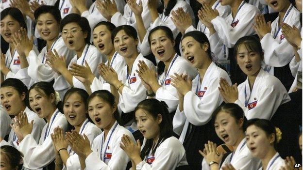 In this photo taken on 21 Aug 2003, North Korean women cheer at the Daegu Universiade Games in Daegu, south of Seoul, South Korea.