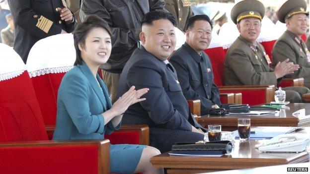 North Korean leader Kim Jong-un and his wife Ri Sol-ju attend the 2014 Combat Flight Contest among commanding officers of the Korean People's Air Force in this undated photo released by North Korea's Korean Central News Agency (KCNA) in Pyongyang on 10 May 2014.