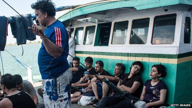 Asylum seekers are seen resting on a boat on 12 May 2013 in Bali, Indonesia.