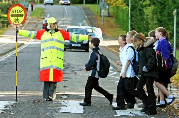 Generic lollipop lady at school crossing