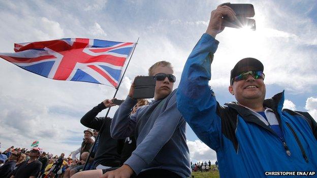 Spectators line the road during the second stage of the Tour de France