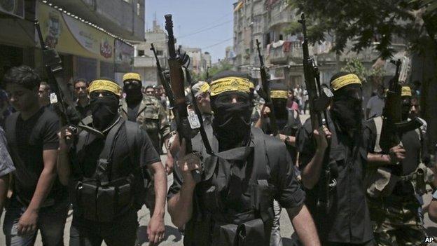 Palestinian militants at a funeral for two fighters killed in an Israeli air strike east of the Bureij refugee camp in central Gaza (7 July 2014)