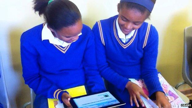 Girls looking at computer tablet