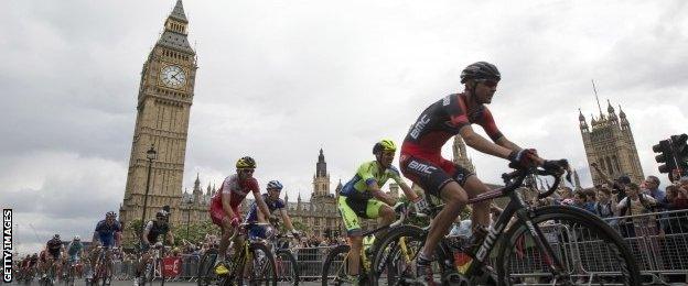 Crowds cheer as cyclists competing in the Tour de France pass through Parliament Square at the end of the races third stage