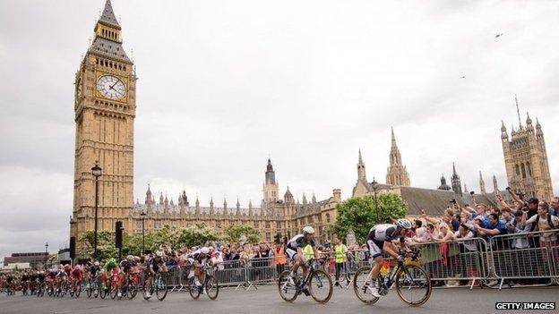 Riders pass the Houses of Parliament