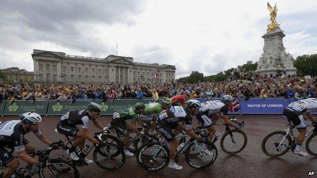 Riders pass Buckingham Palace