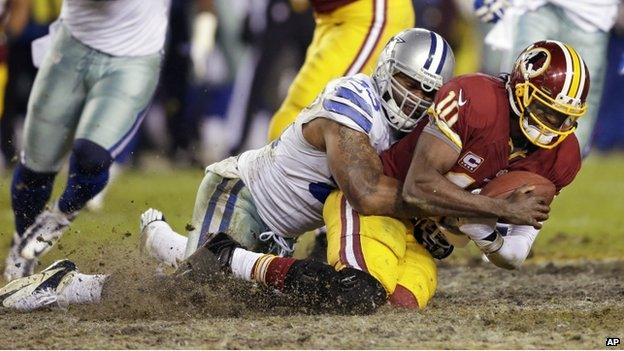 Dallas Cowboys outside linebacker Anthony Spencer (left) sacked Washington Redskins quarterback Robert Griffin III, in Landover, Maryland, on 30 December 2012