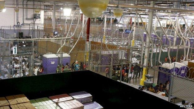 Hundreds of mostly Central American immigrant children are separated into age and gender holding areas as they are being processed and held at the U.S. Customs and Border Protection Nogales Placement Center in Nogales, Arizona 18 June 2014