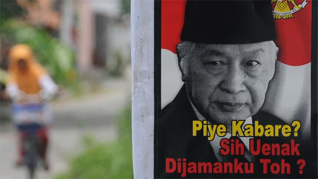 A poster bearing the portrait of Suharto with a slogan 'How are you bro? Still better in my time, no?' is displayed in Karanganyar town in central Java, March 9, 2014