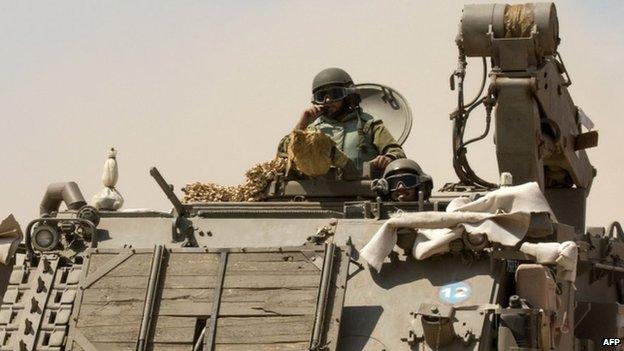 Israeli soldiers on an armoured personnel carrier near the Gaza border. Photo: 7 July 2014