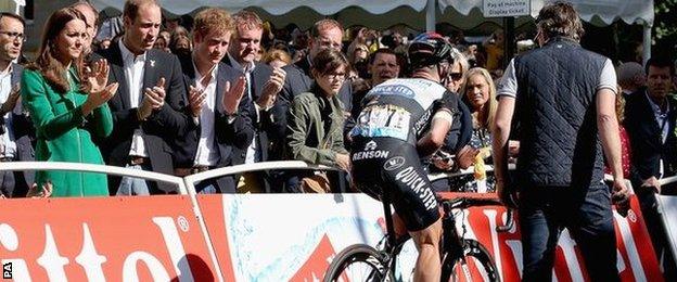 The Duke and Duchess of Cambridge and Prince Harry applaud Cavendish as he rides over the finish line