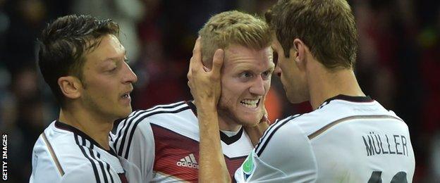 Mesut Ozil, Andre Schurrle and Thomas Muller celebrate a German goal at the 2014 Fifa World Cup