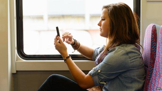 Woman using mobile on train