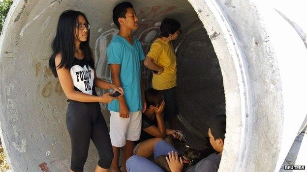 Residents of Nitzan, near the Israeli city of Ashdod, take cover from rocket fire (8 July 2014)