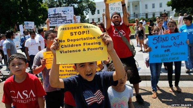 Young children join immigration reform protesters while marching in front of the White House in Washington, DC 7 July 2014