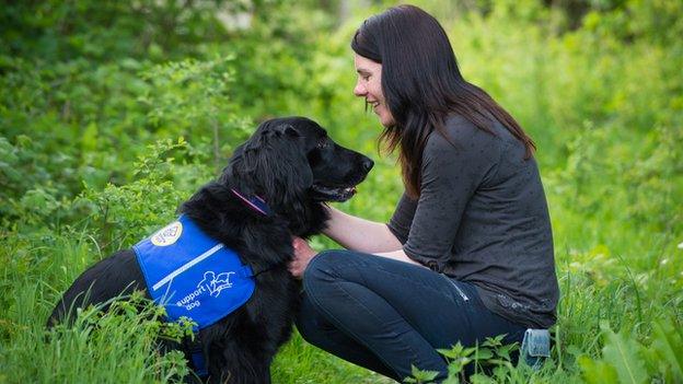 An owner with her seizure alert dog