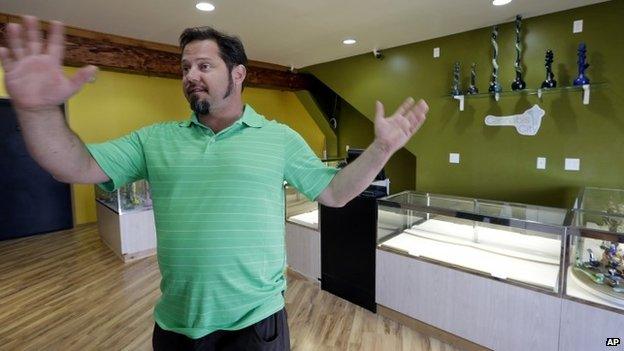 Cannabis City owner James Lathrop gestures as he stands in the middle of his new marijuana shop days before the grand opening in Seattle 2 July 2014