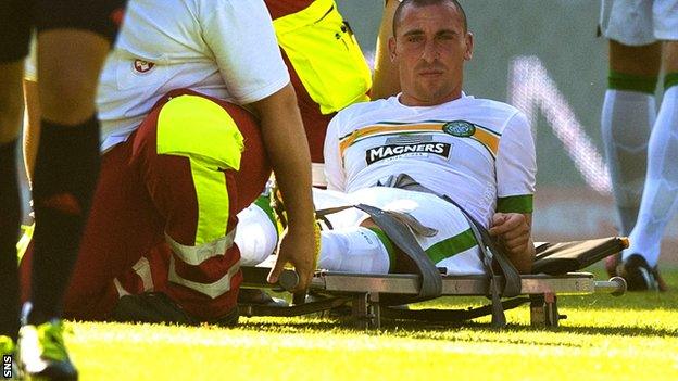 Scott Brown is carried off during his side's friendly against Rapid Vienna