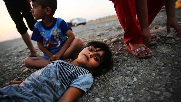 Iraqi children who fled fighting in Mosul prepare to sleep on the ground in Khazair, Iraq. Photo: 3 July 2014